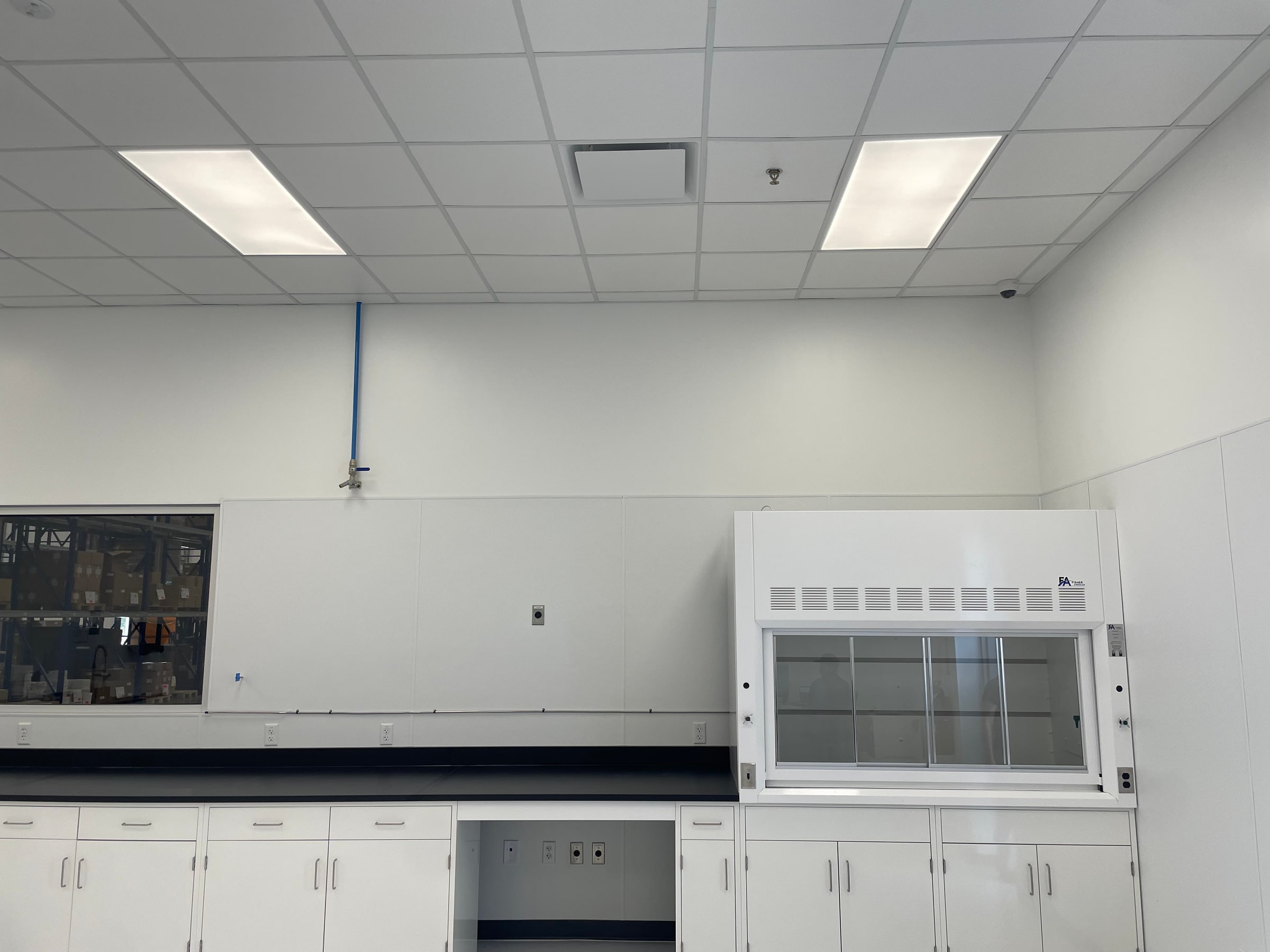 Laboratory fume hood integrated with commercial cabinets and work surfaces