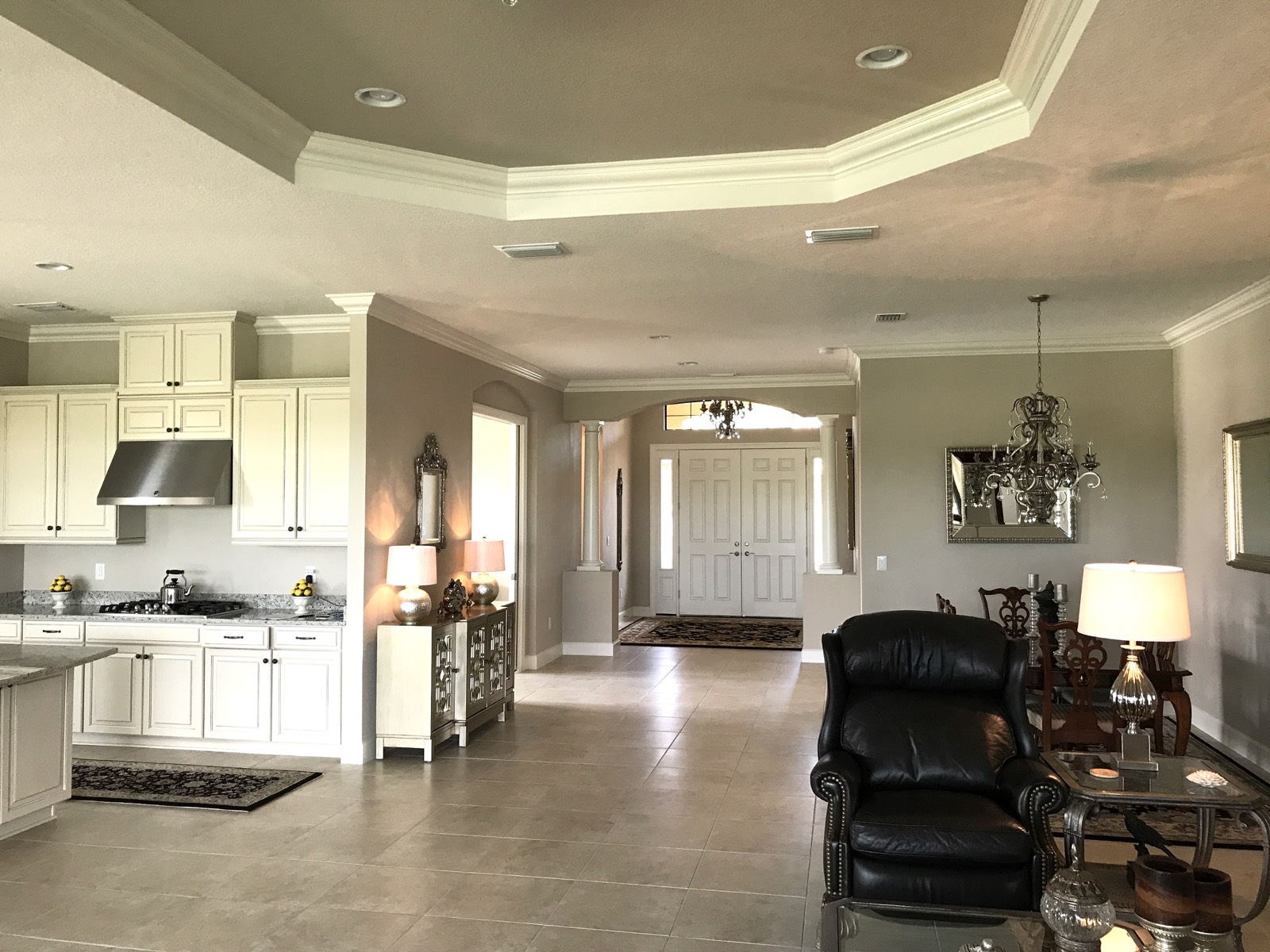 Florida interior remodel featuring custom cabinetry, crown molding, and an open floor plan